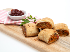 Gluten-free layered cake by Melinda’s Gluten Free Goodies, featuring a frosted sponge cake displayed