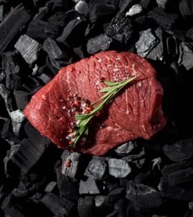Raw beef cuts including steaks and ribs on a board with herbs and spices, representing Melbourne Mea