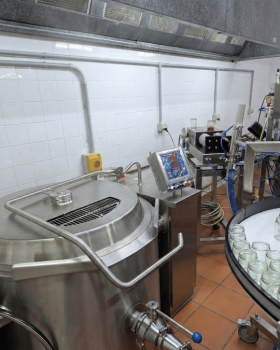 Contract manufacturing image showing a bottle of red sauce being poured against a black background.