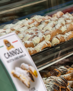 Bowl of Crostoli King crostoli pastries dusted with icing sugar, showcasing thin, crispy Italian swe
