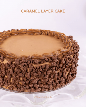 Cream & Crumb family-size layer cakes in clear clamshell packaging displayed in a supermarket refrig
