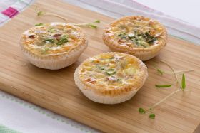 Gluten-free layered cake by Melinda’s Gluten Free Goodies, featuring a frosted sponge cake displayed