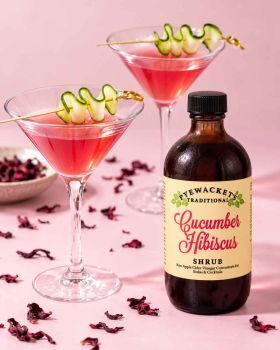 Pyewackets Traditional Apple Cider Vinegar Shrub being poured from an amber glass bottle into a drin