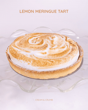 Cream & Crumb family-size layer cakes in clear clamshell packaging displayed in a supermarket refrig