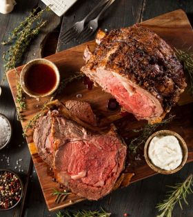 Raw beef cuts including steaks and ribs on a board with herbs and spices, representing Melbourne Mea