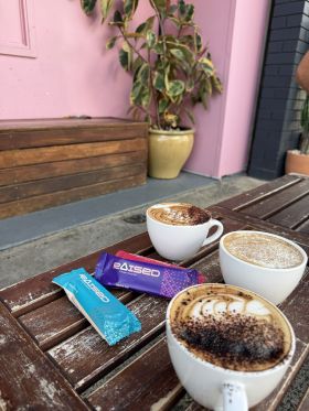 Raised collagen protein bars in Salted Caramel, Chocolate Almond and Açaí flavours on wooden table