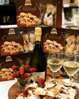 Bowl of Crostoli King crostoli pastries dusted with icing sugar, showcasing thin, crispy Italian swe