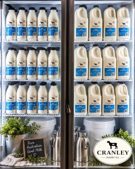 Cranley Dairy Co. raw goat milk and freeze-dried goat milk products displayed with a dairy goat in a