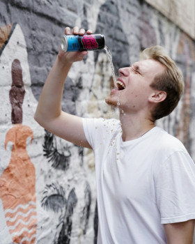God’s Water logo in bold pink lettering with a cream outline on a dark blue background with wave-lik