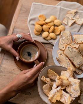 Bowl of Crostoli King crostoli pastries dusted with icing sugar, showcasing thin, crispy Italian swe