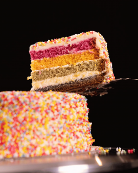 Cream & Crumb family-size layer cakes in clear clamshell packaging displayed in a supermarket refrig