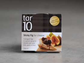 tar10 caramelised balsamic vinegar being drizzled over cheese and bread on a charcuterie board