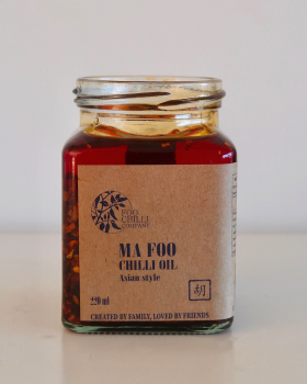 chilli oil being poured into glass jar filled with chilli flakes, Foo Chilli Company small-batch gou