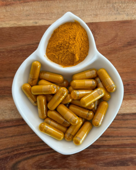 Indus Farms superfood powders with vibrant yellow and red fruit powders surrounded by mango slices a