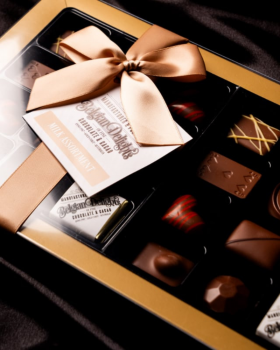 Luxury gift box of assorted Belgian Delights chocolates presented in a gold-trimmed box with ribbon