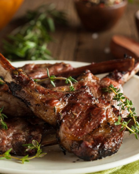 Raw beef cuts including steaks and ribs on a board with herbs and spices, representing Melbourne Mea