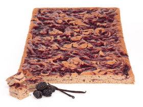 Gluten-free layered cake by Melinda’s Gluten Free Goodies, featuring a frosted sponge cake displayed