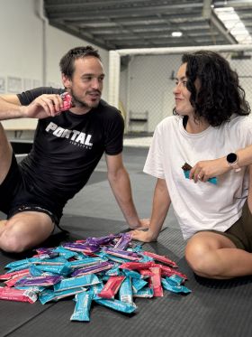 Raised collagen protein bars in Salted Caramel, Chocolate Almond and Açaí flavours on wooden table
