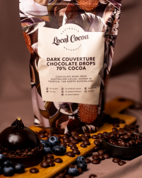 Local Cocoa Australia logo reading “Local Cocoa – Naturally” over an aerial view of lush green fores