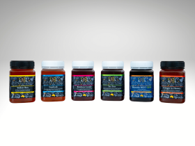 Assorted sizes of AB’s raw Australian honey in plastic tubs with yellow and white lids displayed on