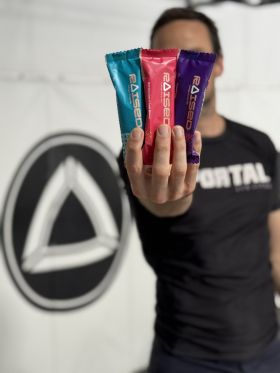 Raised collagen protein bars in Salted Caramel, Chocolate Almond and Açaí flavours on wooden table