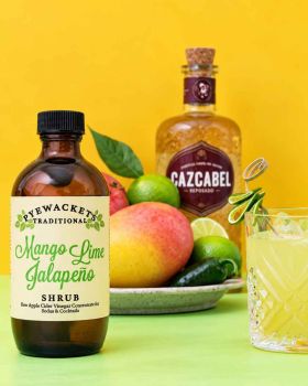 Pyewackets Traditional Apple Cider Vinegar Shrub being poured from an amber glass bottle into a drin