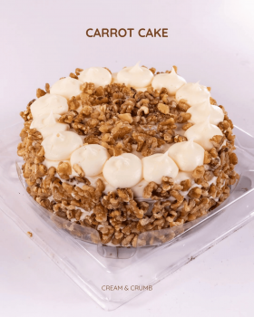 Cream & Crumb family-size layer cakes in clear clamshell packaging displayed in a supermarket refrig