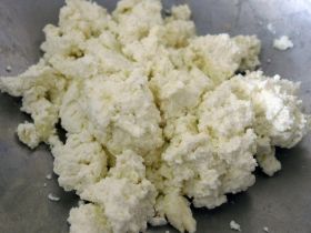 Harigon Gourmet Foods black caviar and red caviar in crystal bowls with crepes on a white tablecloth