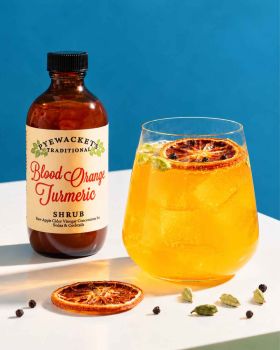 Pyewackets Traditional Apple Cider Vinegar Shrub being poured from an amber glass bottle into a drin