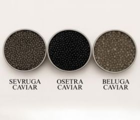 Harigon Gourmet Foods black caviar and red caviar in crystal bowls with crepes on a white tablecloth