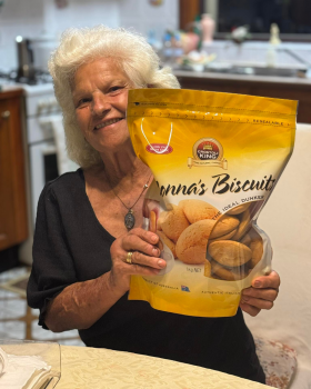 Bowl of Crostoli King crostoli pastries dusted with icing sugar, showcasing thin, crispy Italian swe