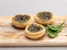 Gluten-free layered cake by Melinda’s Gluten Free Goodies, featuring a frosted sponge cake displayed