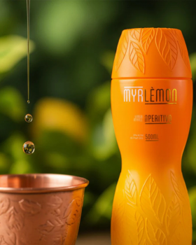 Myrlemon Australian botanical spirit bottle with lemon myrtle and citrus, displayed by the beach sho