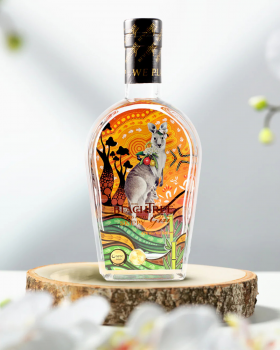 Beachtree Ocean Blue gin liqueur bottle displayed beside a koala holding a purple cocktail at a beac