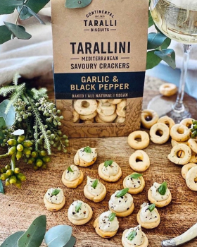 Assorted Continental Tarallini savoury crackers in various flavours arranged on a white table with a
