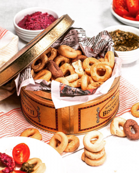 Assorted Continental Tarallini savoury crackers in various flavours arranged on a white table with a