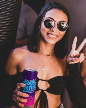 God’s Water logo in bold pink lettering with a cream outline on a dark blue background with wave-lik