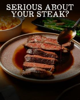 Grilled beef steaks cooking over flame on barbecue grill, showcasing premium wholesale meat from Few