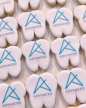 Artisan Delights logo with text reading “Iced Gingerbread Cookies” and “Custom Promotional Cookies”