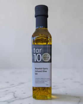 tar10 caramelised balsamic vinegar being drizzled over cheese and bread on a charcuterie board