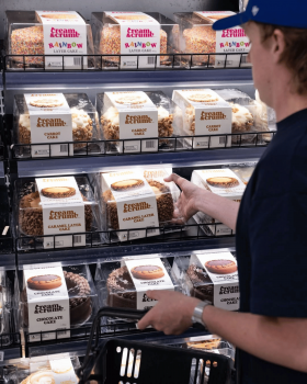 Cream & Crumb family-size layer cakes in clear clamshell packaging displayed in a supermarket refrig